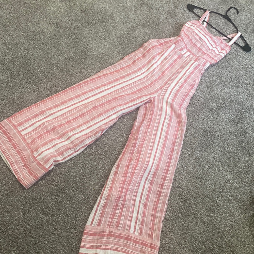 I am selling a Lulu‘s pink and white striped romper really cute open back